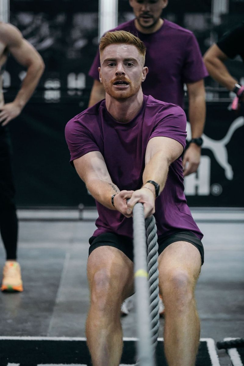Coach Cam pulling rope at a HYROX competition