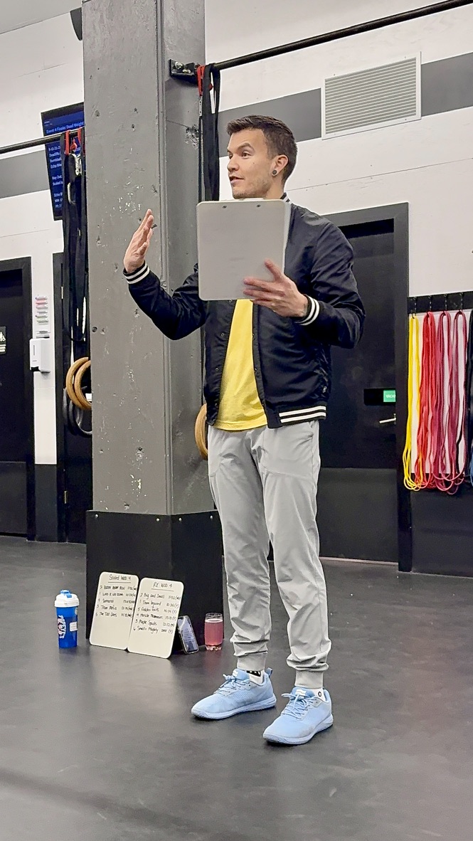 Coach briefing the class before a workout