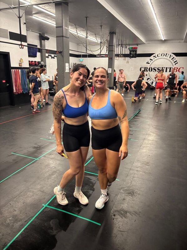 A small group of CrossFit BC members connecting after class, smiling and chatting