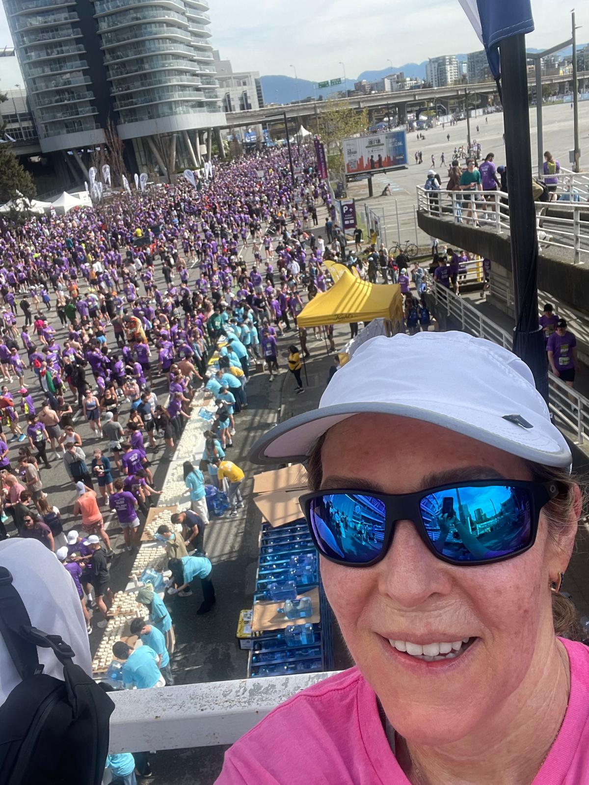 Thousands of Sun Run runners in purple shirts crowding Vancouver streets