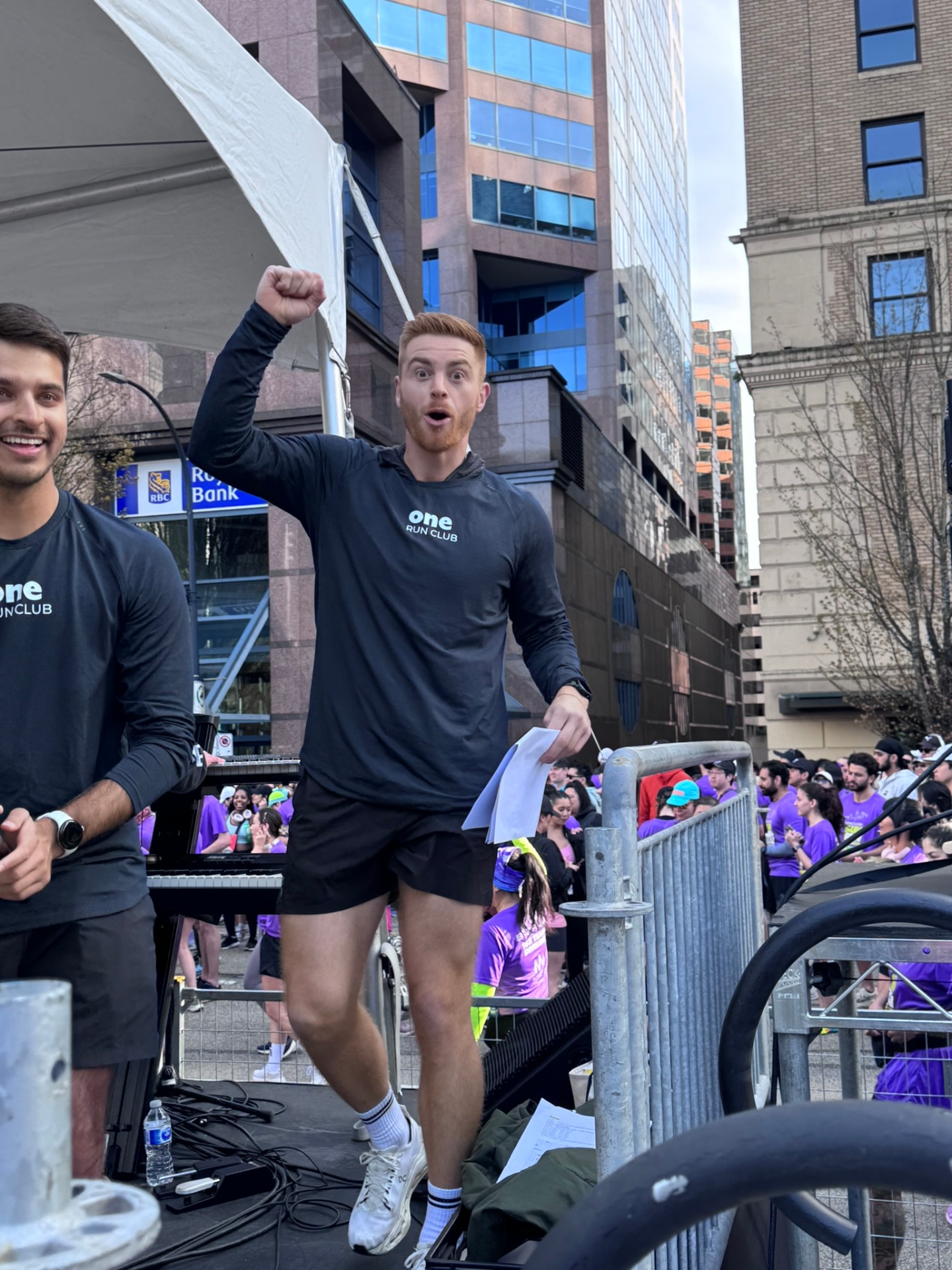 CrossFit BC coach on the Sun Run stage cheering runners